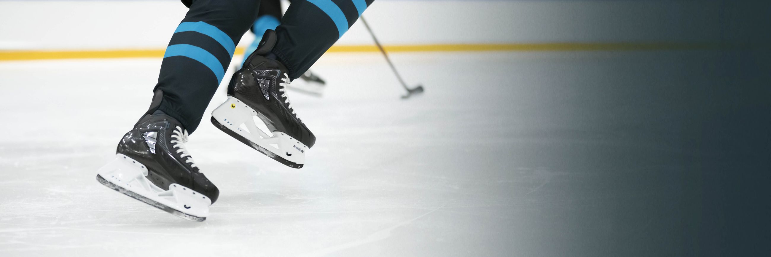 Ice hockey player wearing Marsblade i2 skates during game play.