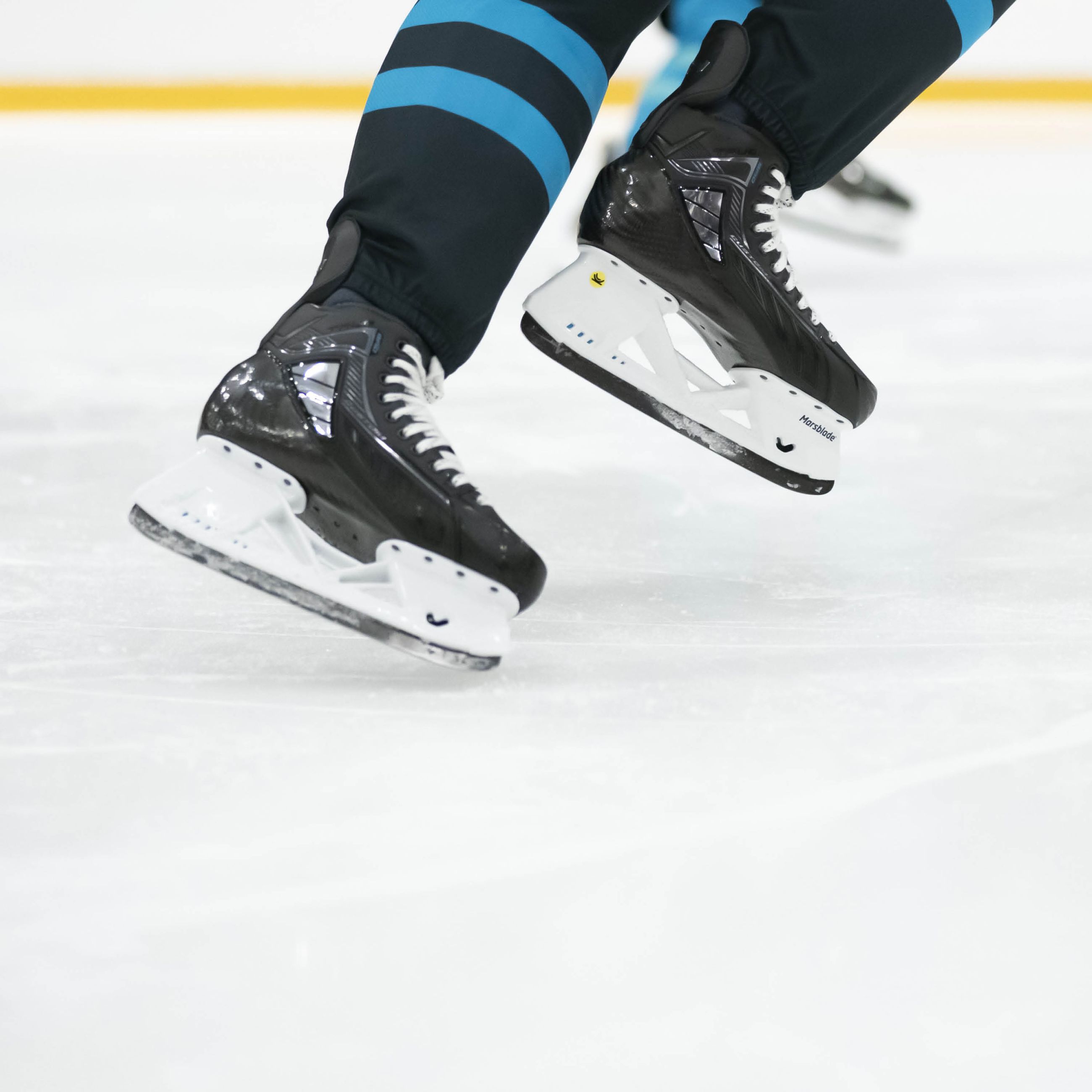 Ice hockey player wearing Marsblade i2 skates during game play.